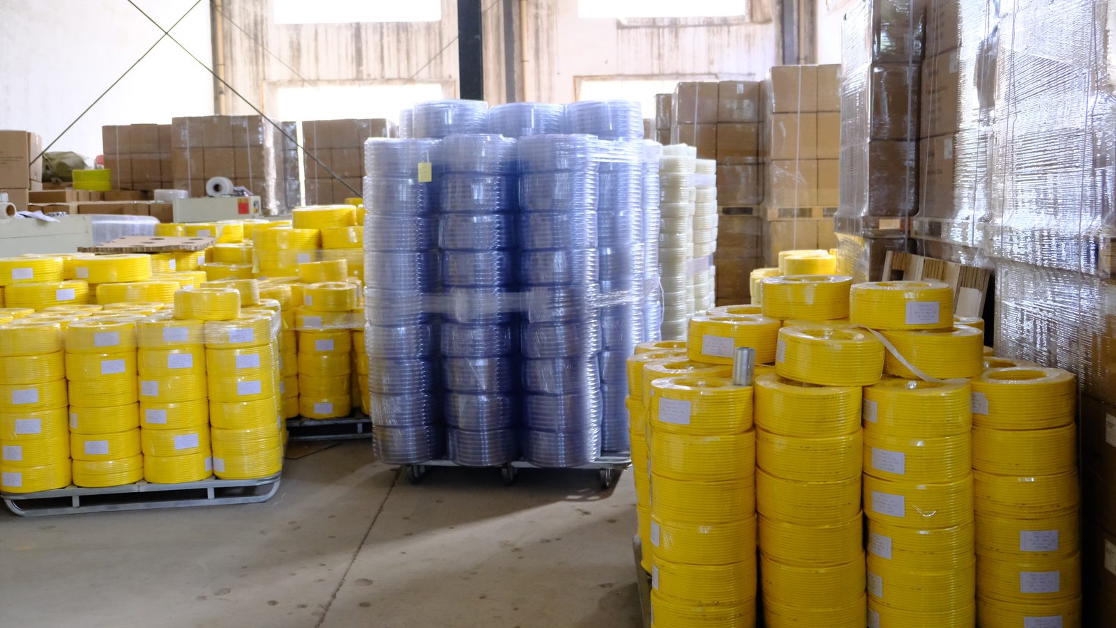 PVC hose warehouse stocked with finished rolls